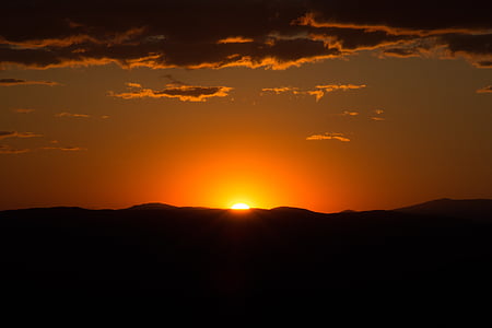 landscape photography of golden sun peeping against mountain thumbnail