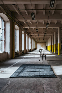 Interior of an abandoned building hall with yellow pillars thumbnail