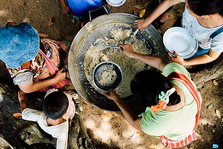 group of people scooping rice thumbnail