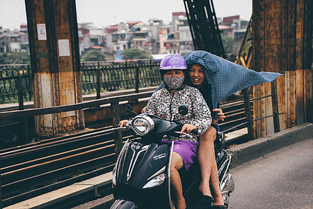two person riding on motorcycle passing on bridge during daytime thumbnail