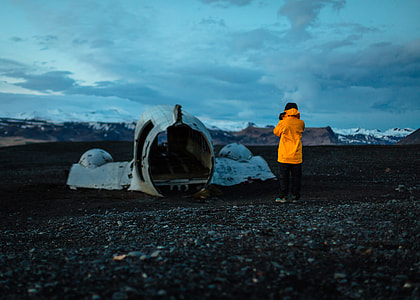 man standing in front of wrecked airplane thumbnail