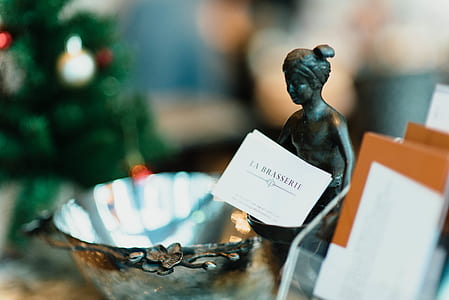 female figurine beside stainless steel bowl thumbnail