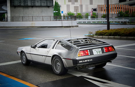 grey DMC DeLorean coupe on road thumbnail