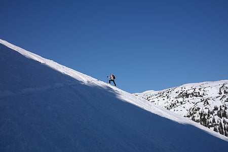 person climbing on snow field thumbnail