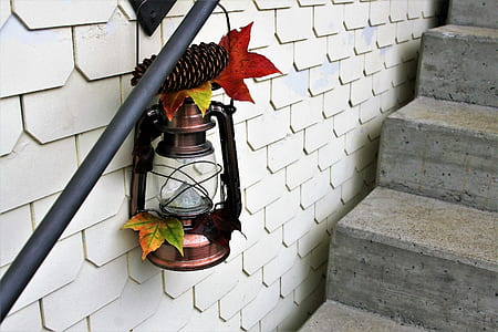 brown steel lantern hanging on black tube thumbnail