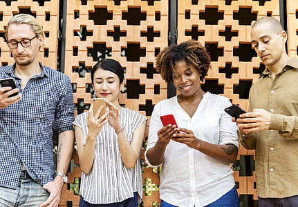 two men and two women using smartphones thumbnail