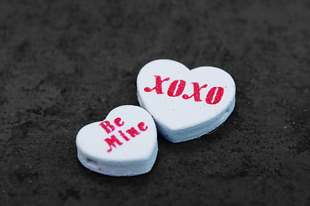 two white heart-shaped printed stones on black surface thumbnail