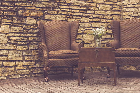 two brown wing chairs near wall and table thumbnail