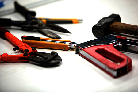 bolt cutter, staple gun, and box cutter on white surface thumbnail