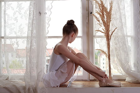ballerina sitting on brown wooden pavement thumbnail
