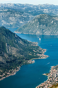 aerial photo of green mountain beside body of water at daytime thumbnail