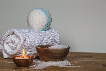 brown wooden bowl and candle near white textile thumbnail