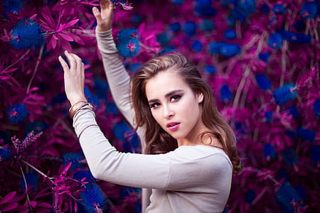 Woman Holding Purple and Blue Flowers thumbnail