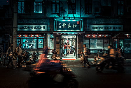 people walking near kanji script labeled building at nighttime thumbnail