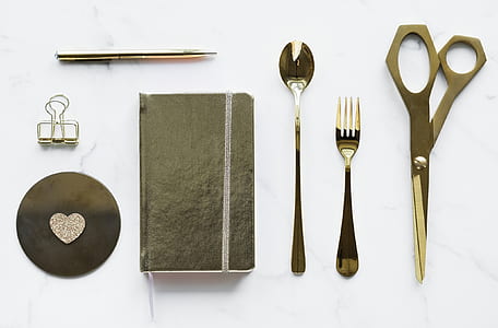 gray stainless steel cutlery on white wooden surface thumbnail