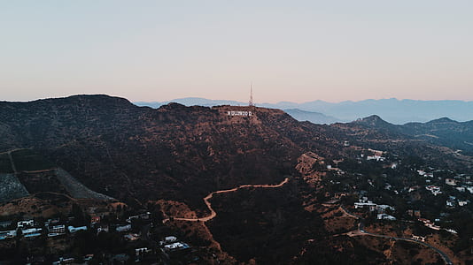 aerial photo of village beside mountain thumbnail