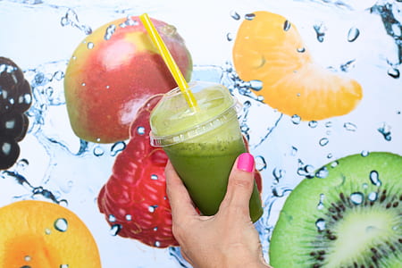 person's left hand holding fruit smoothie thumbnail