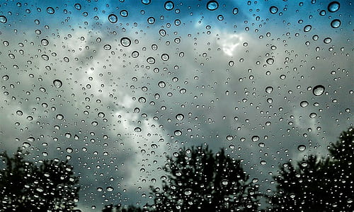 water drop on glass during daytime thumbnail