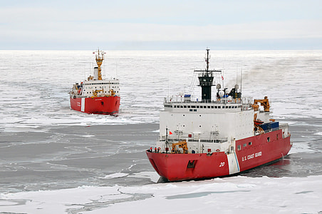 two white-and-red boats on body of icy water thumbnail