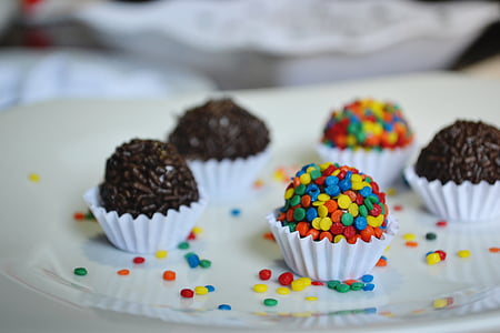four chocolate truffles on plate thumbnail