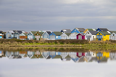 assorted-color houses near body of water thumbnail