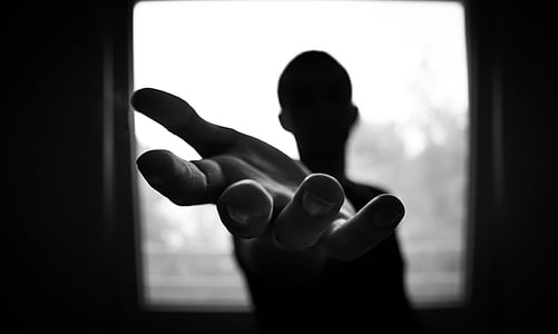 silhouette of man raising left palm thumbnail
