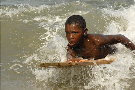 boy riding brown board on wave thumbnail