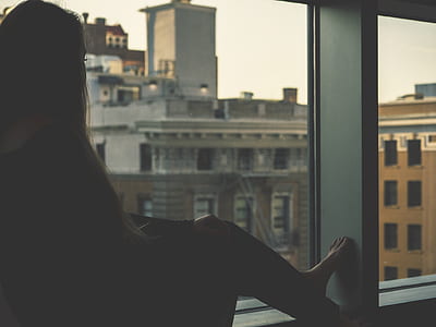 woman sitting in front of window thumbnail