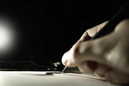 person writing using a pen thumbnail