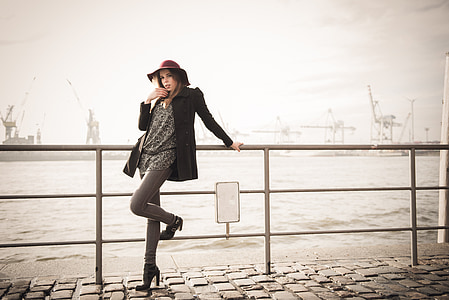 woman in black coat posing for photo thumbnail