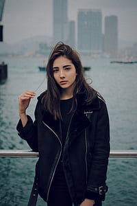 woman standing holding her hair near water thumbnail