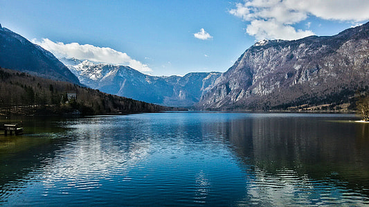 Lake with mountains under blue sky thumbnail
