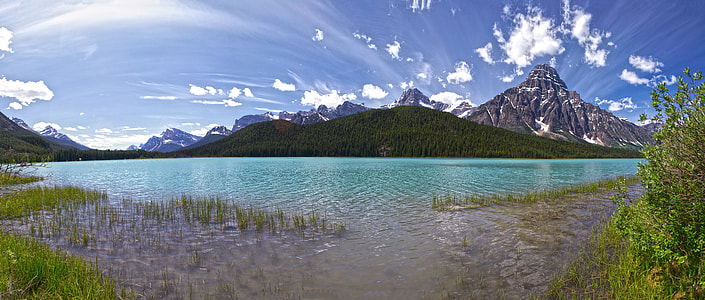 landscape photography of mountain under blue sky thumbnail