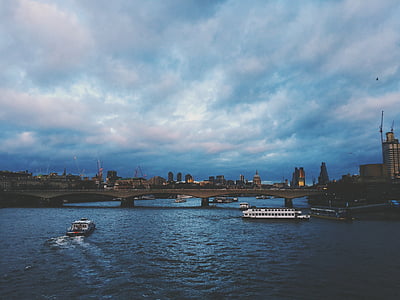 brown bridge over body of water during sunset thumbnail