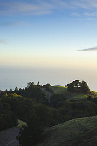 green hill during daytime thumbnail