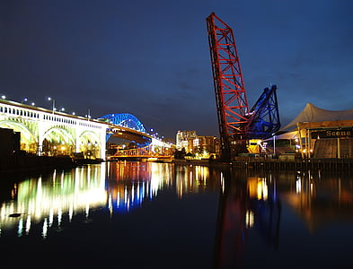 body of water with bridge during night time thumbnail