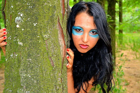 woman in blue face paint during daytime thumbnail