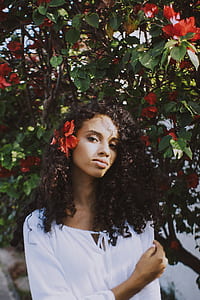 woman standing near red Bougainvillea flowers thumbnail