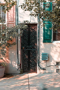 brown floral cutout metal storm door on beige concrete wall thumbnail