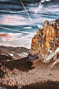 rocky mountain and pine trees under cloudy sky thumbnail