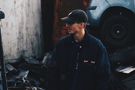man standing beside vehicle thumbnail