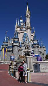 man and woman taking picture infront of Walt Disney castle thumbnail