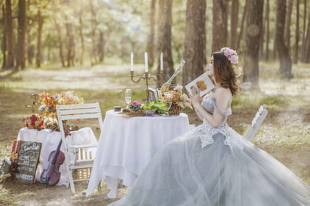 woman in gray wedding gown sitting on chair thumbnail