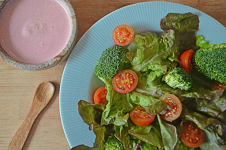 vegetables on blue plate near bowl on table thumbnail