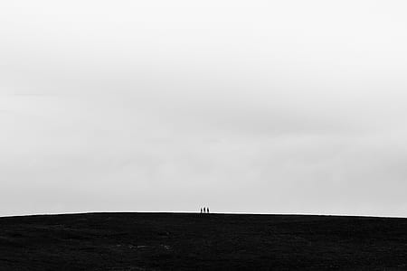 three person standing at the field during day thumbnail