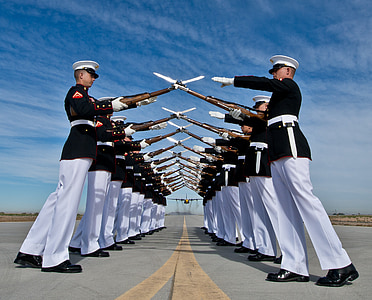 cadets forming two lines while their rifle crossed creating a dome pathway on airport photo thumbnail