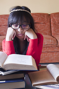 woman sitting down in front of book thumbnail