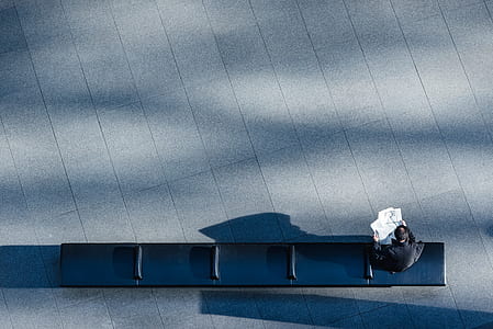 man sitting on black bench thumbnail