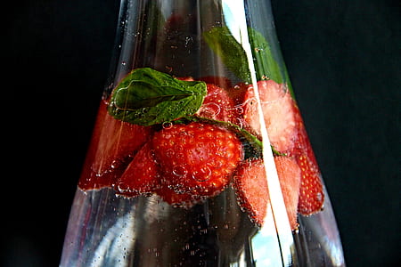 clear liquid filled glass bottle with strawberries thumbnail