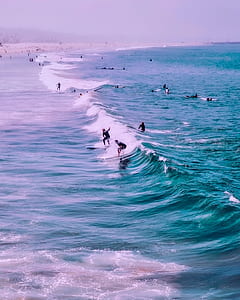 people surfing during daytime thumbnail